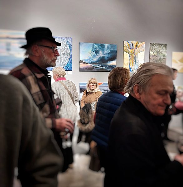 Wernisaż w galerii sztuki ZPAP OW. Goście oglądają wystawy malarstwa, w tym obraz Trzepot, którego autorką jest Karina Jaźwińska.